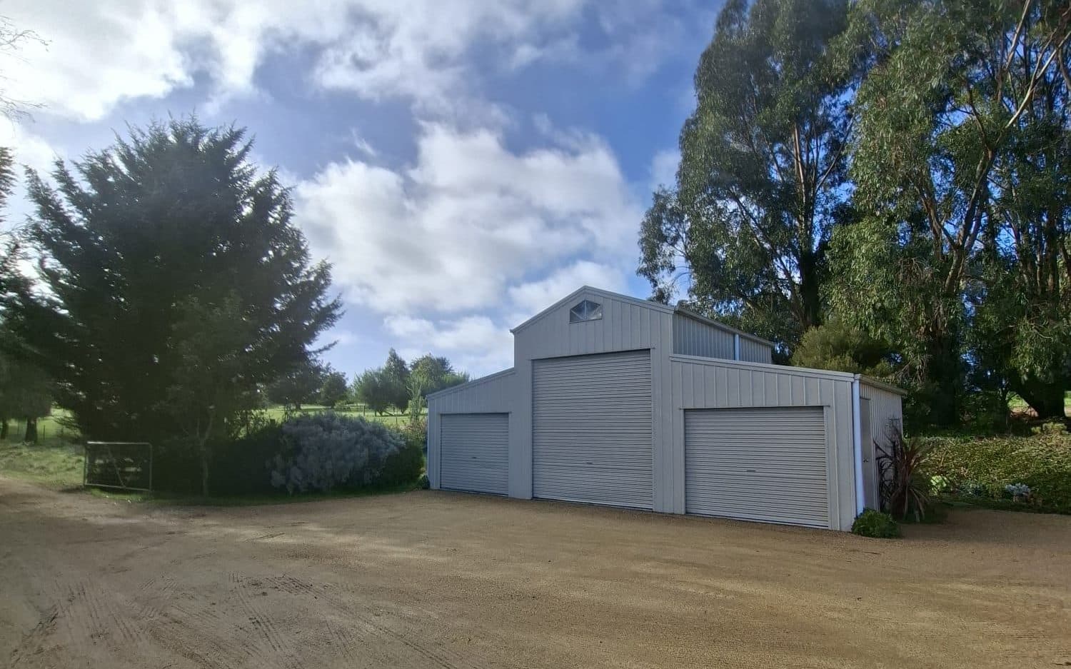 gravel turning area in front of a farm shed on a rural property